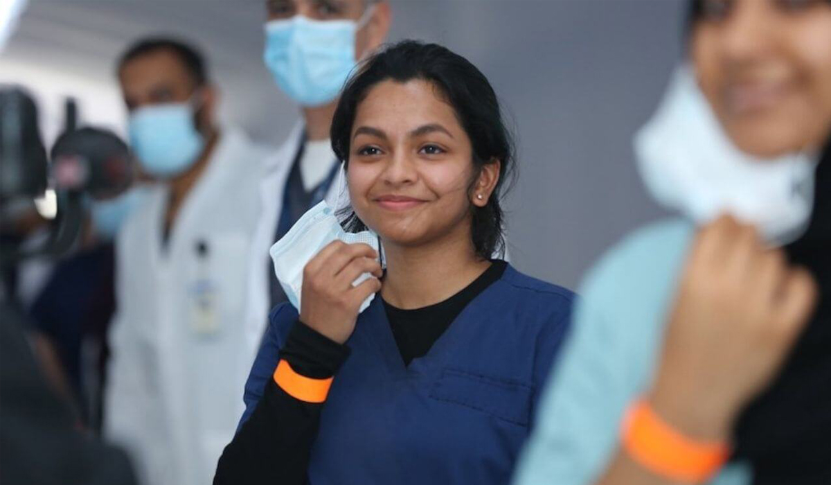 Woman Removing Mask